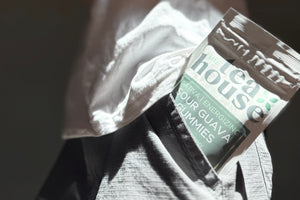 Person holding a box with 'tea house' branding